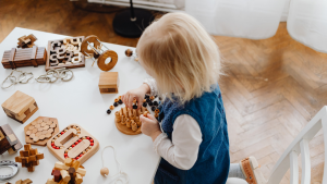 child playing at a desk at nursery in edinburgh